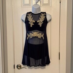 Elegant navy blue dance costume with cream colored embellishment.